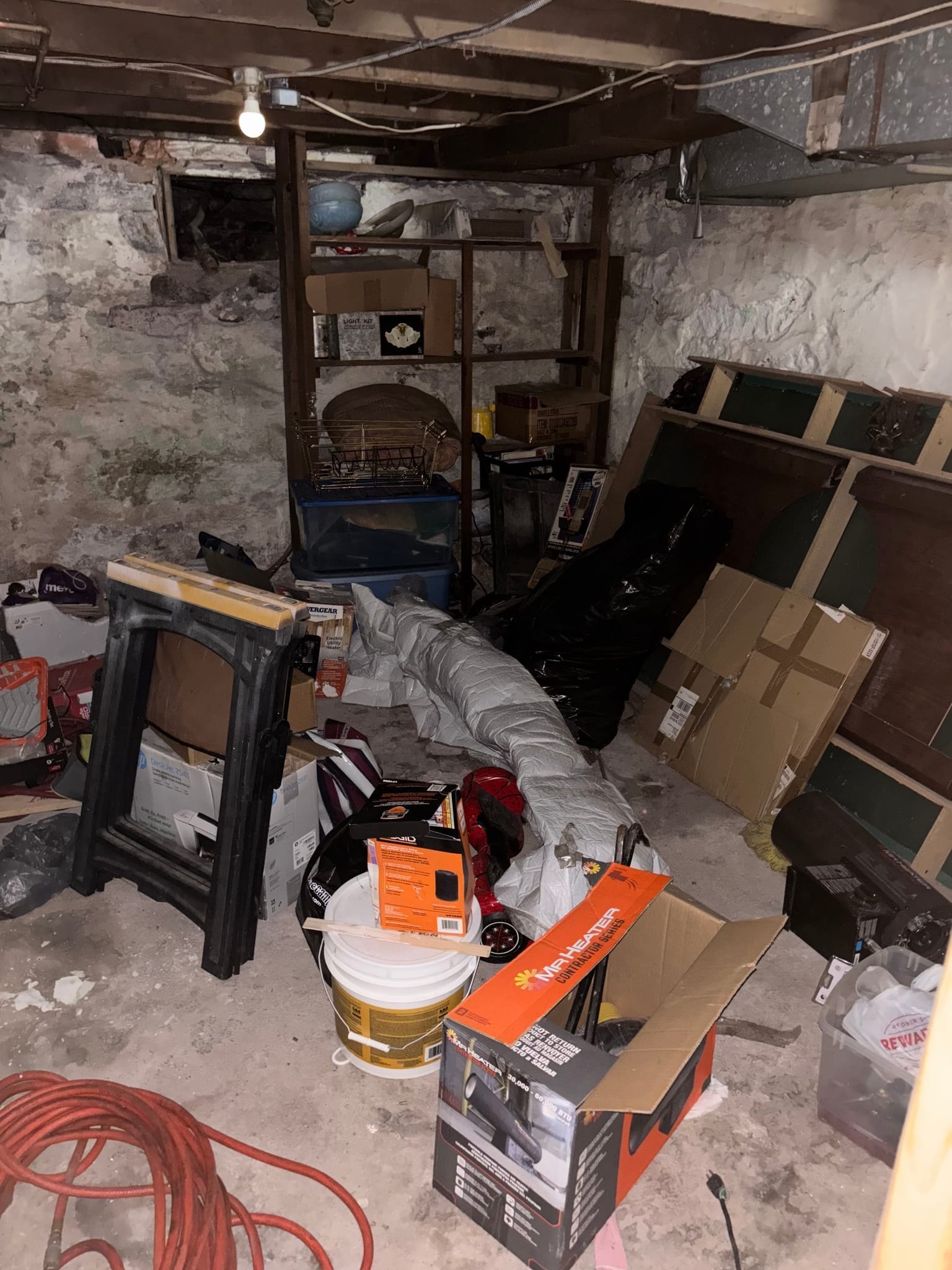 Before: garage packed with furniture, boxes and junk