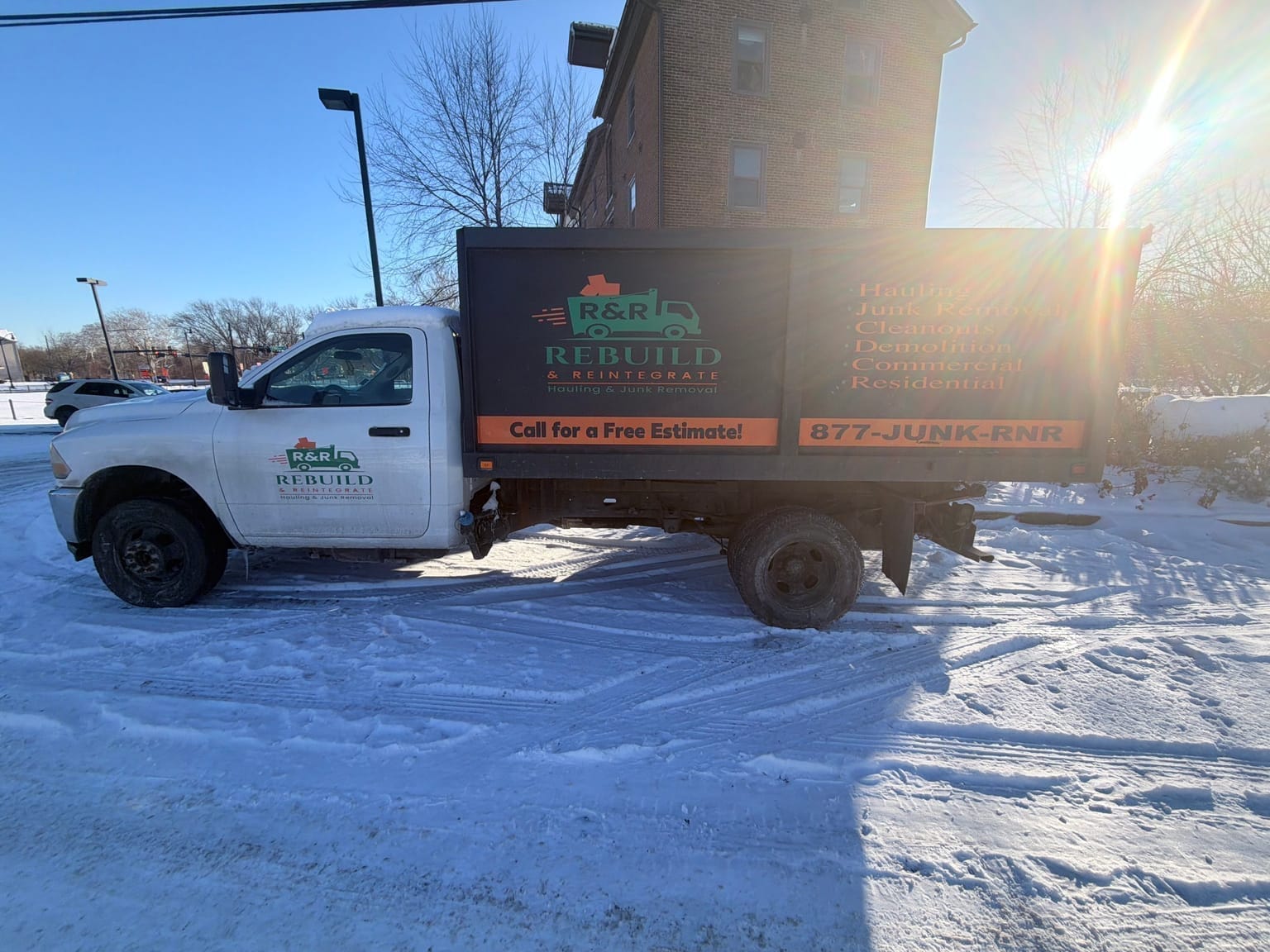 R&R crew loading furniture onto a junk removal truck
